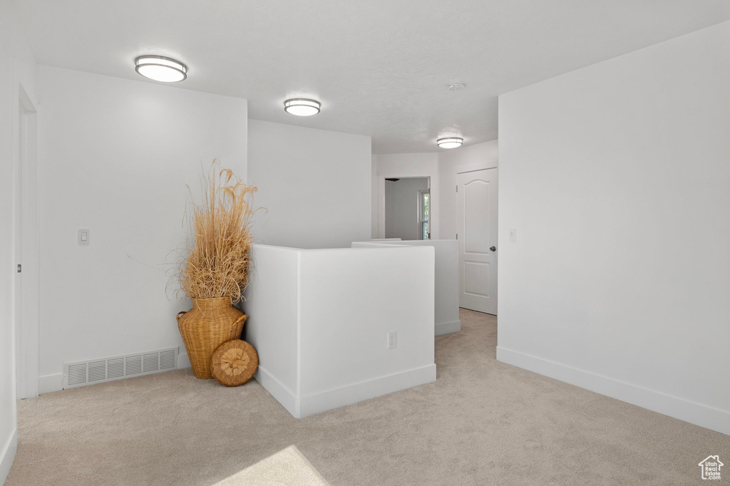 Carpeted empty room featuring baseboards