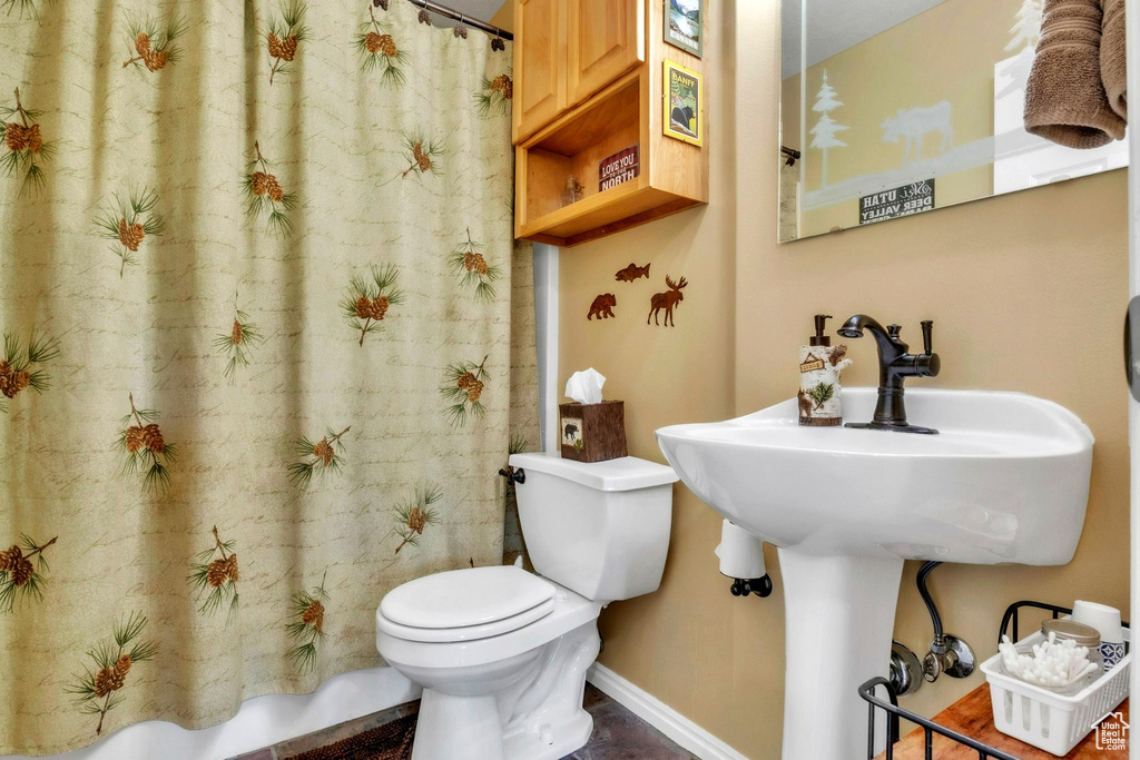 Bathroom with toilet and a shower with curtain