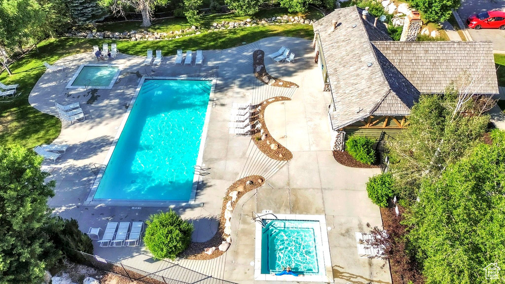 Aerial view of property and surrounding area featuring a pool