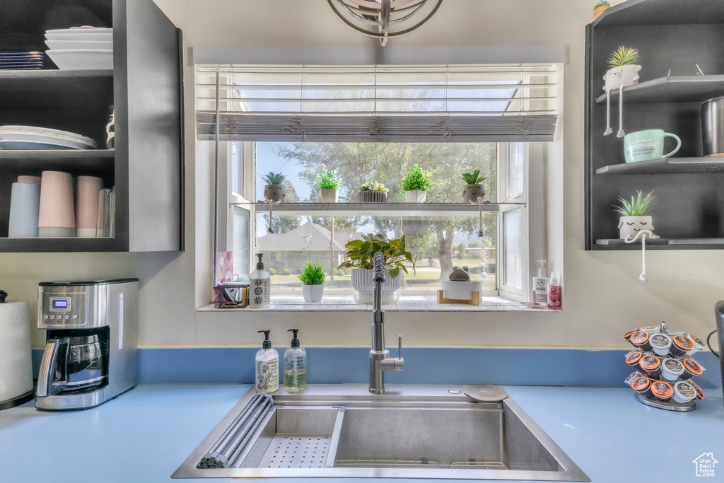 Kitchen featuring a sink and light countertops