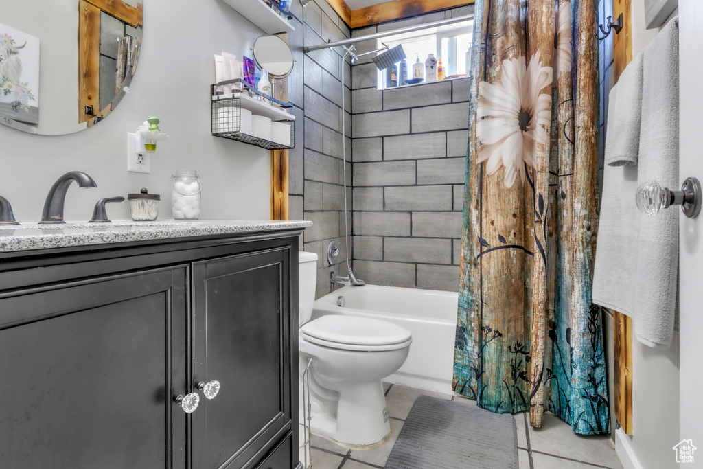 Full bathroom featuring vanity, tile patterned floors, and shower / bath combo