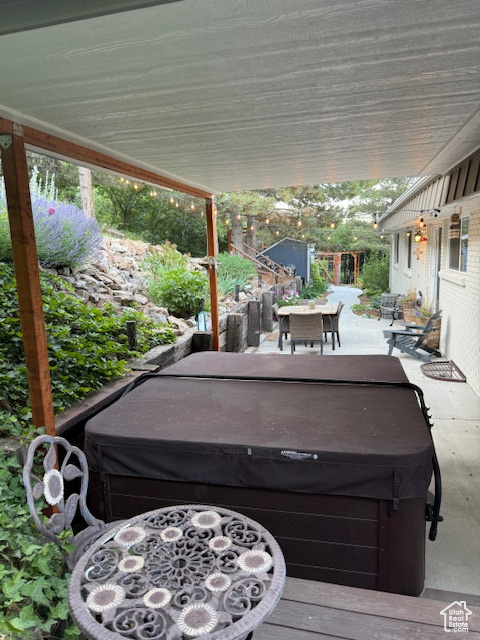 View of patio / terrace featuring a hot tub and outdoor dining area