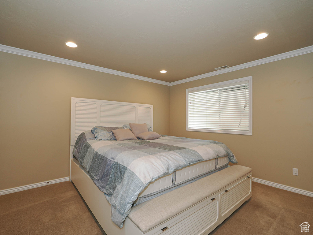 Bedroom featuring light carpet, recessed lighting, and ornamental molding