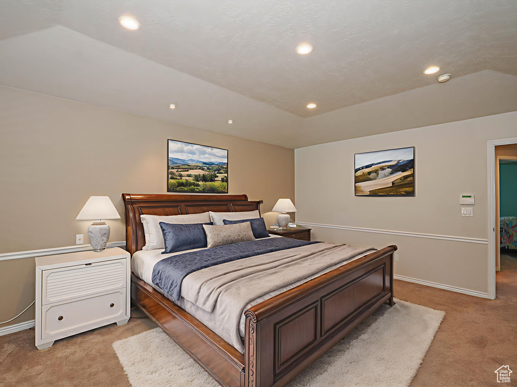Bedroom with light carpet and recessed lighting