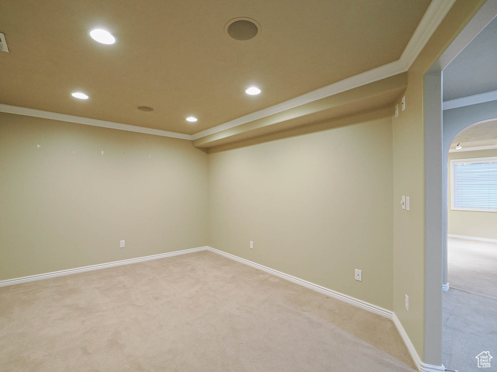 Spare room with light carpet, ornamental molding, and recessed lighting