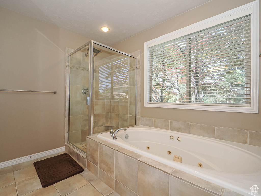 Bathroom with a shower stall, a whirlpool tub, tile patterned flooring, and recessed lighting