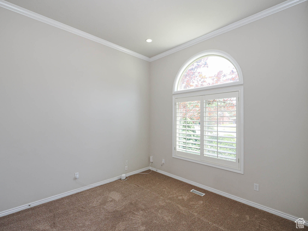 Carpeted empty room featuring crown molding and recessed lighting