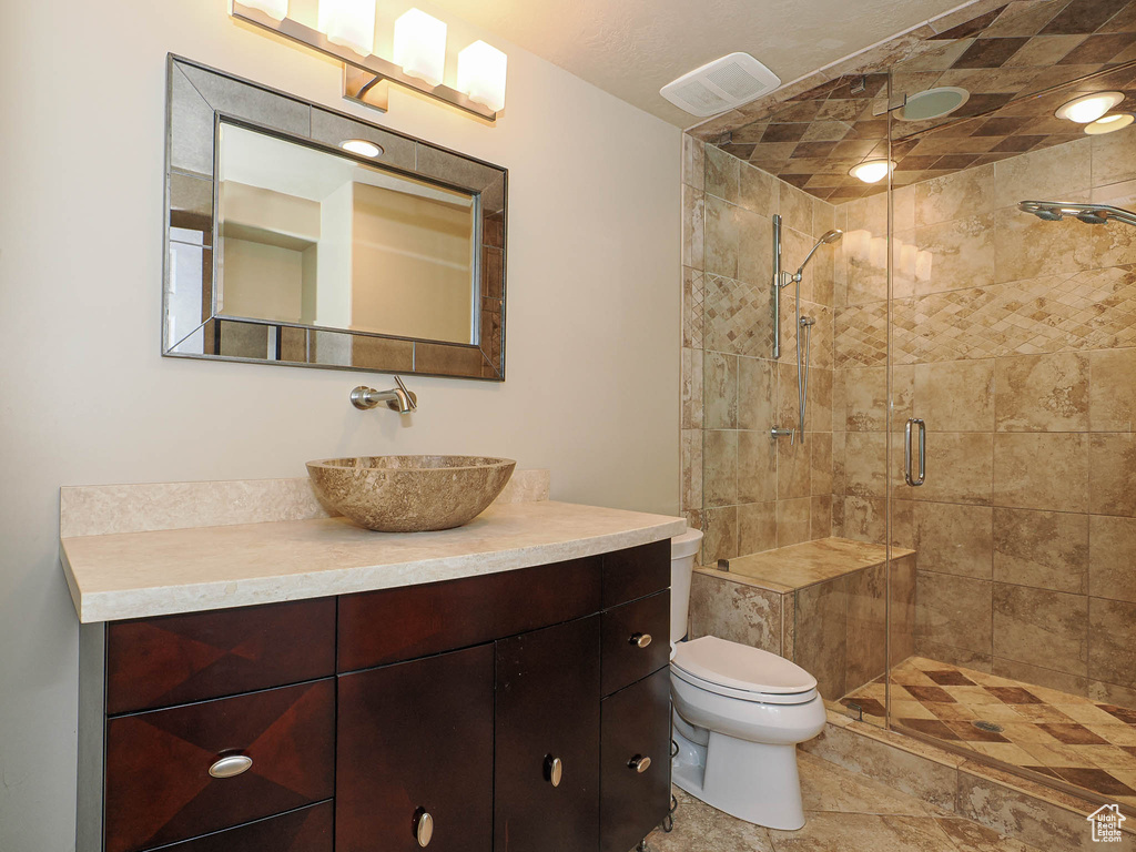 Bathroom featuring vanity and a shower stall