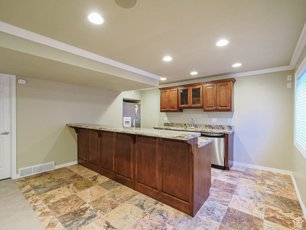 Kitchen featuring dishwasher, white fridge with ice dispenser, ornamental molding, a peninsula, and a breakfast bar