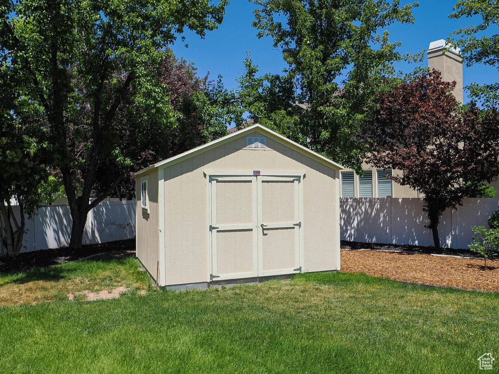 View of shed with a fenced backyard
