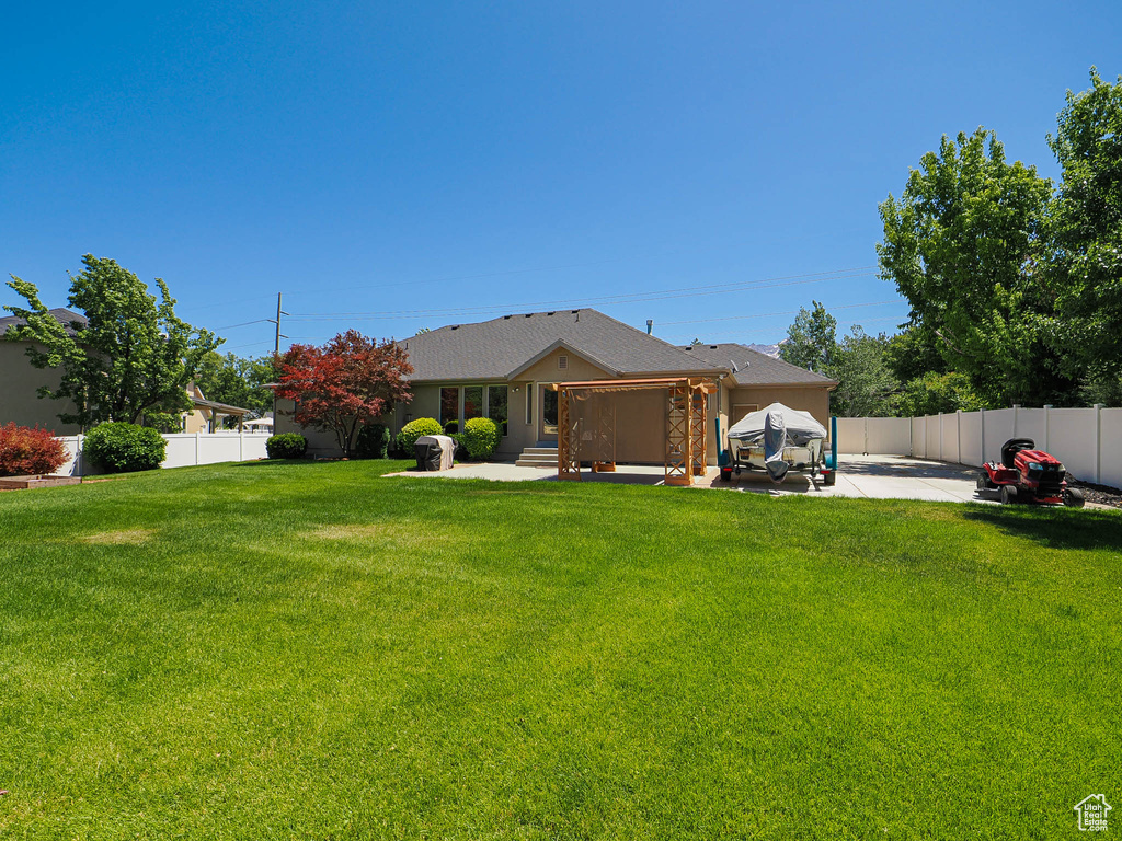 View of front of property featuring a patio area and a fenced backyard