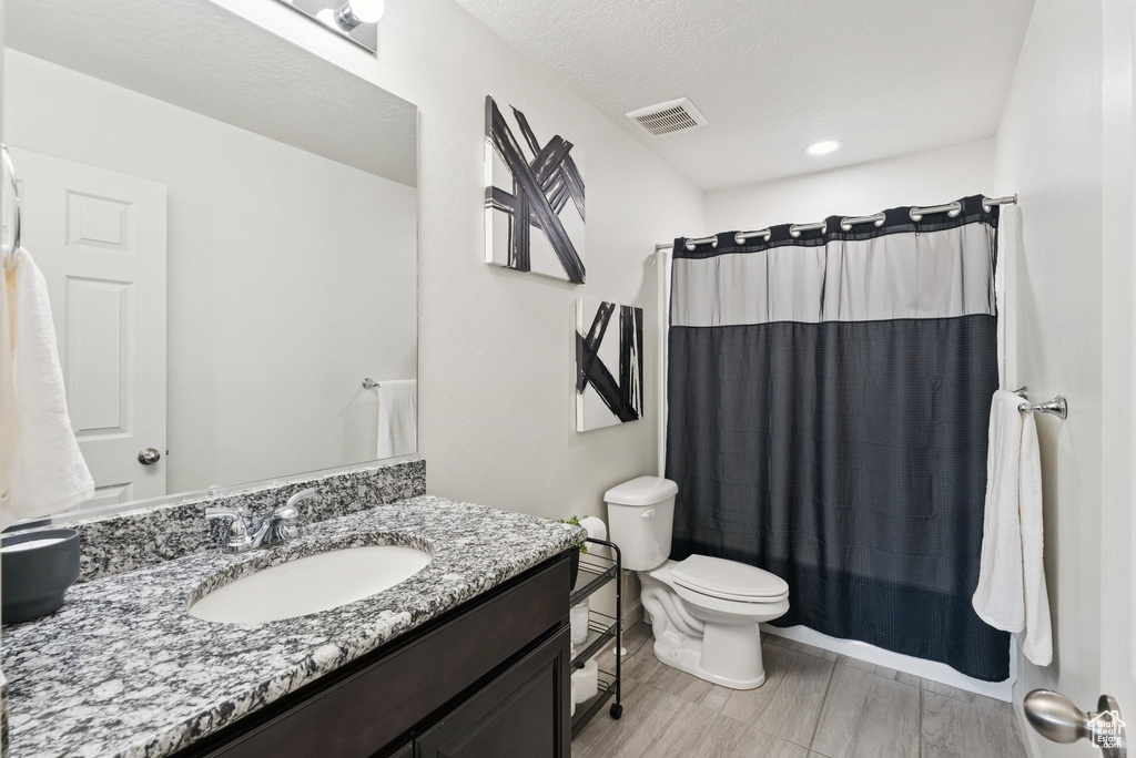 Bathroom with vanity, curtained shower, and recessed lighting