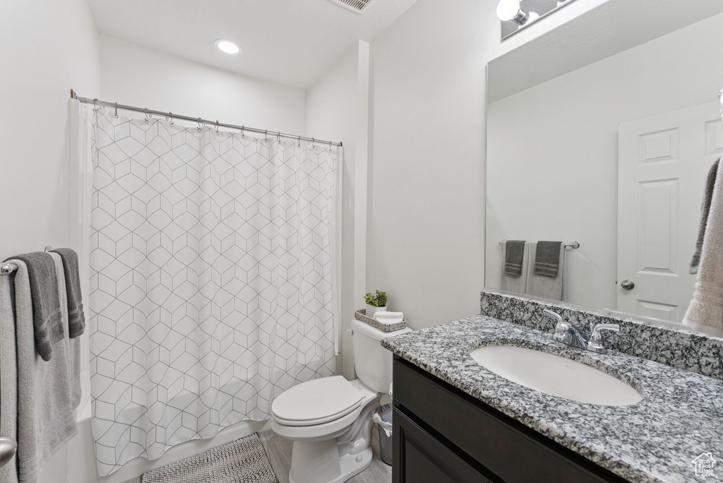 Full bathroom with vanity and shower / tub combo
