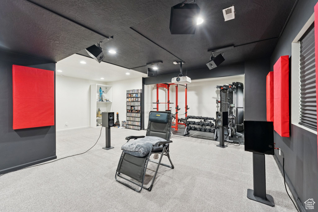 Workout area featuring recessed lighting, carpet floors, track lighting, and a textured ceiling