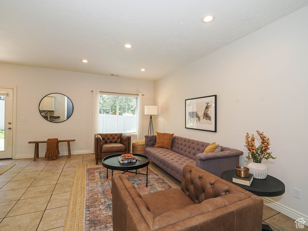 Living room featuring light tile patterned flooring and recessed lighting