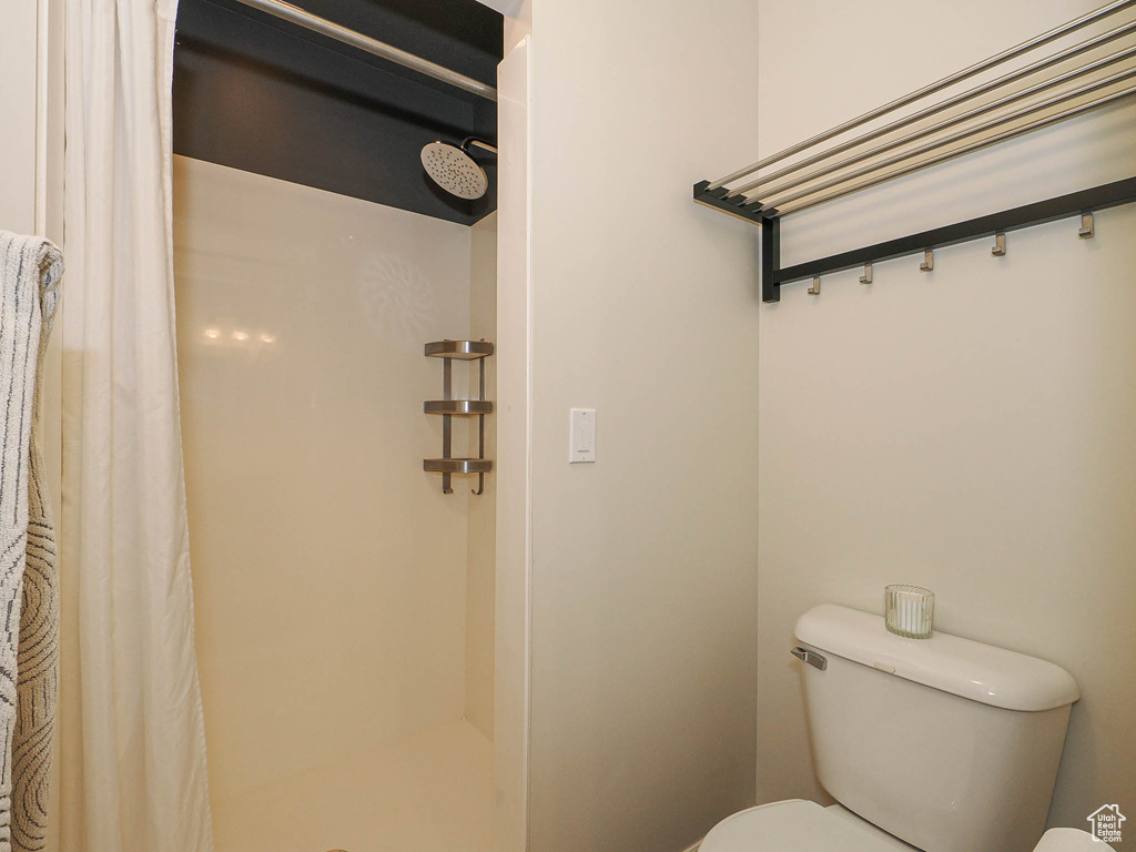 Bathroom featuring toilet and a shower stall