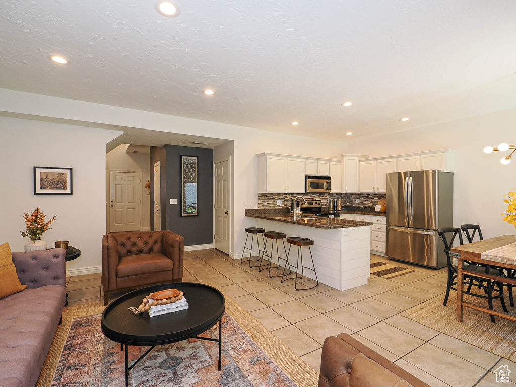 Living area with recessed lighting and light tile patterned floors