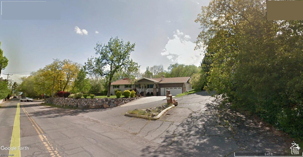 Single story home featuring driveway and an attached garage