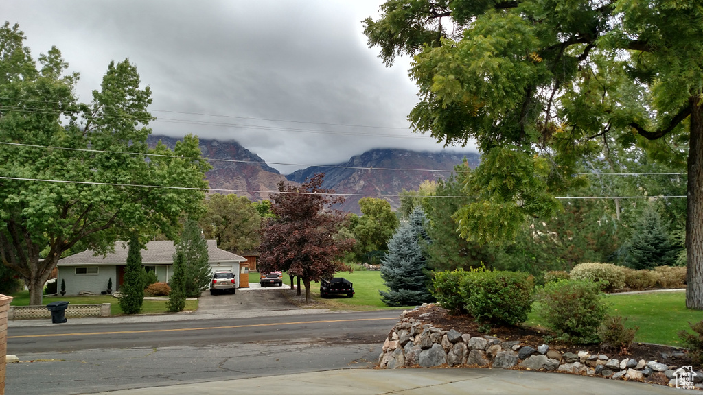 View of asphalt street featuring a mountain view