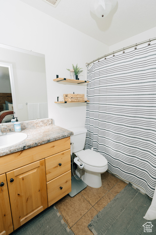 Bathroom featuring vanity, tile patterned floors, and curtained shower