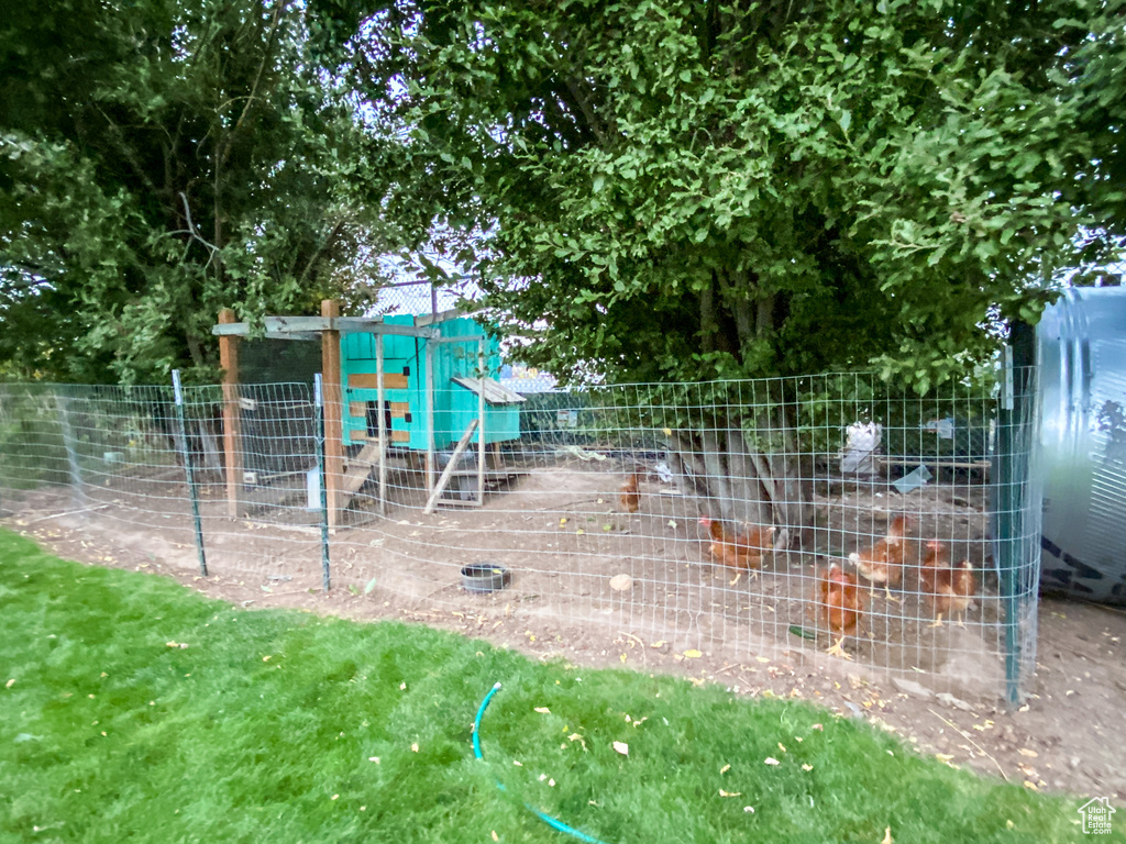 View of play area with exterior structure and an outbuilding