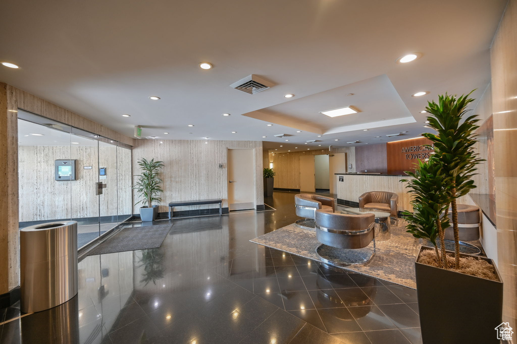 Common area with wallpapered walls and recessed lighting