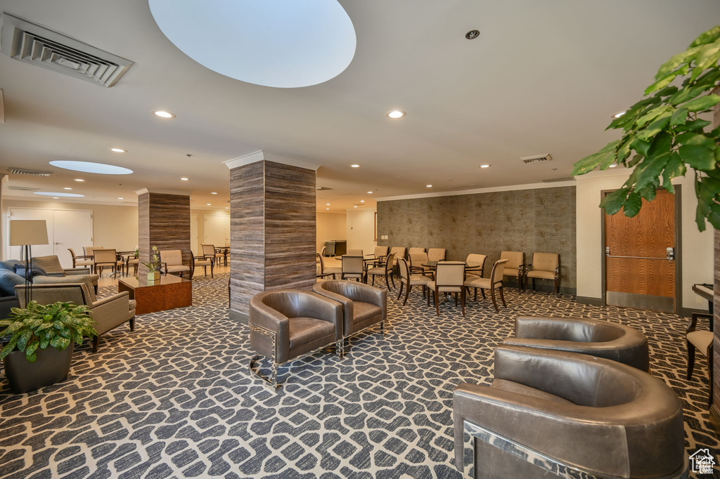 Common area with crown molding and recessed lighting