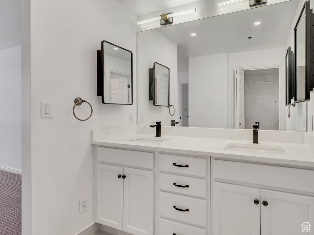 Bathroom featuring double vanity and recessed lighting