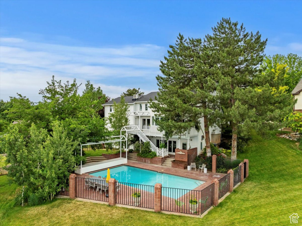 View of swimming pool featuring stairs and a patio