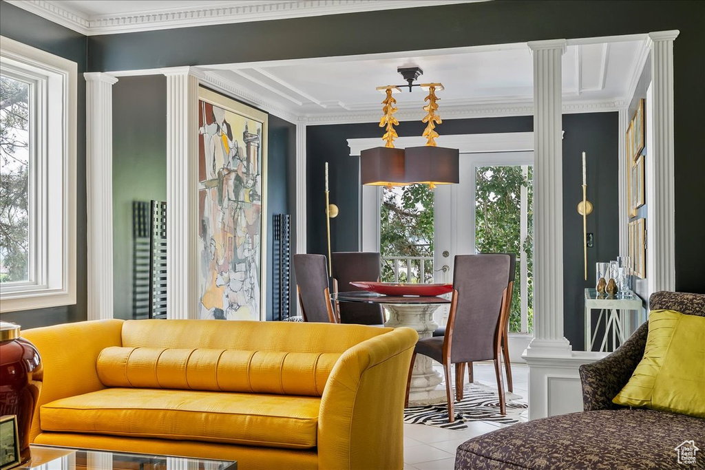 Tiled dining room featuring decorative columns and crown molding