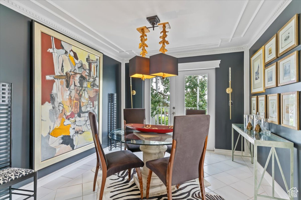 Dining room featuring crown molding and light tile patterned floors