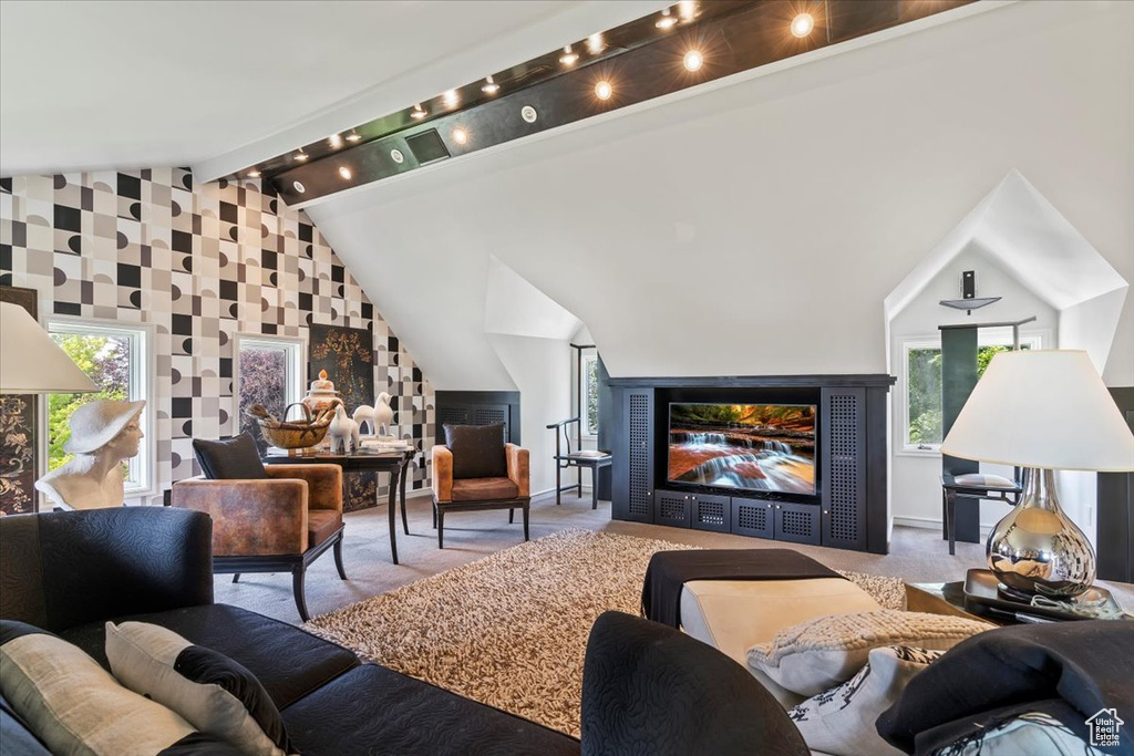 Living area featuring healthy amount of natural light and carpet