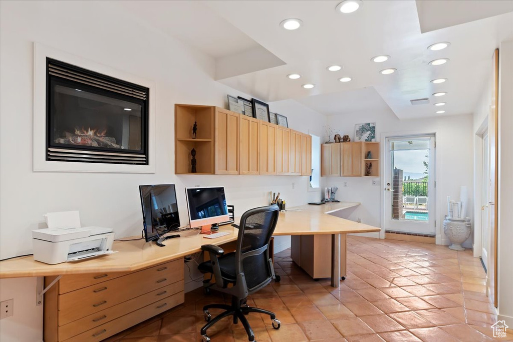 Office space with recessed lighting, built in study area, and light tile patterned floors