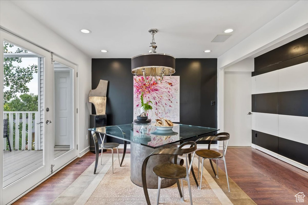 Dining room with recessed lighting, wood finished floors, and a chandelier