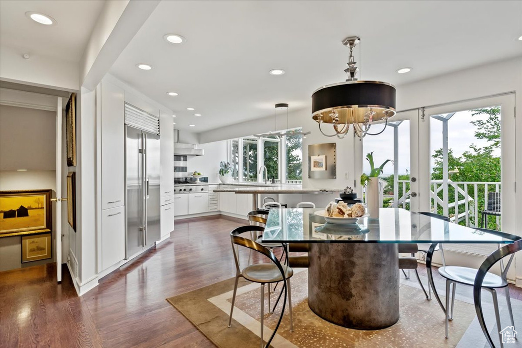 Dining space with recessed lighting, dark wood-style floors, and french doors