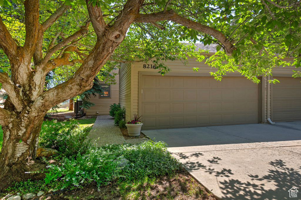 Garage featuring concrete driveway