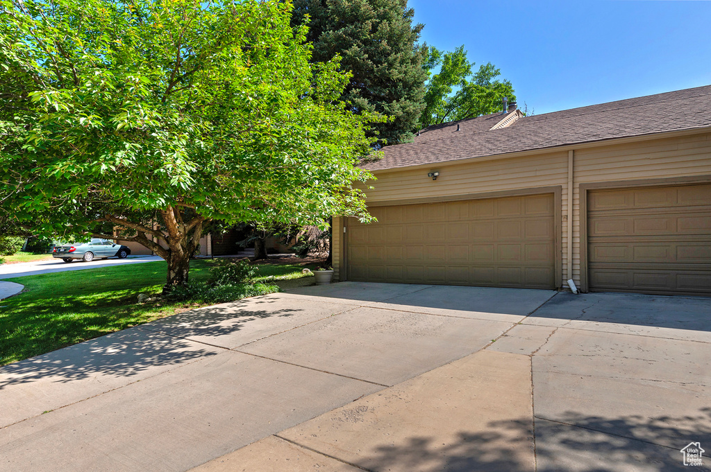 Garage featuring driveway