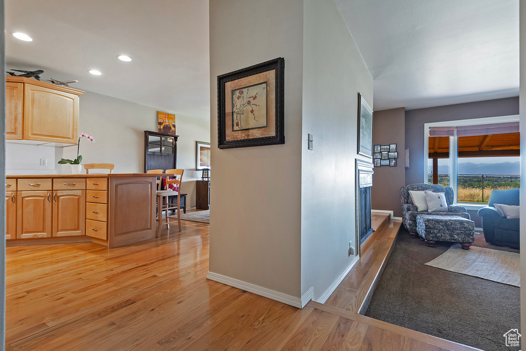 Corridor featuring light wood-style floors and recessed lighting