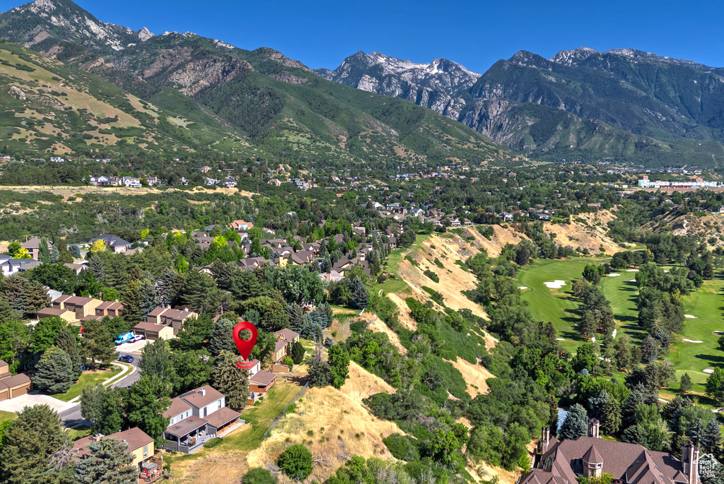 View of mountain backdrop with nearby suburban area and a golf course