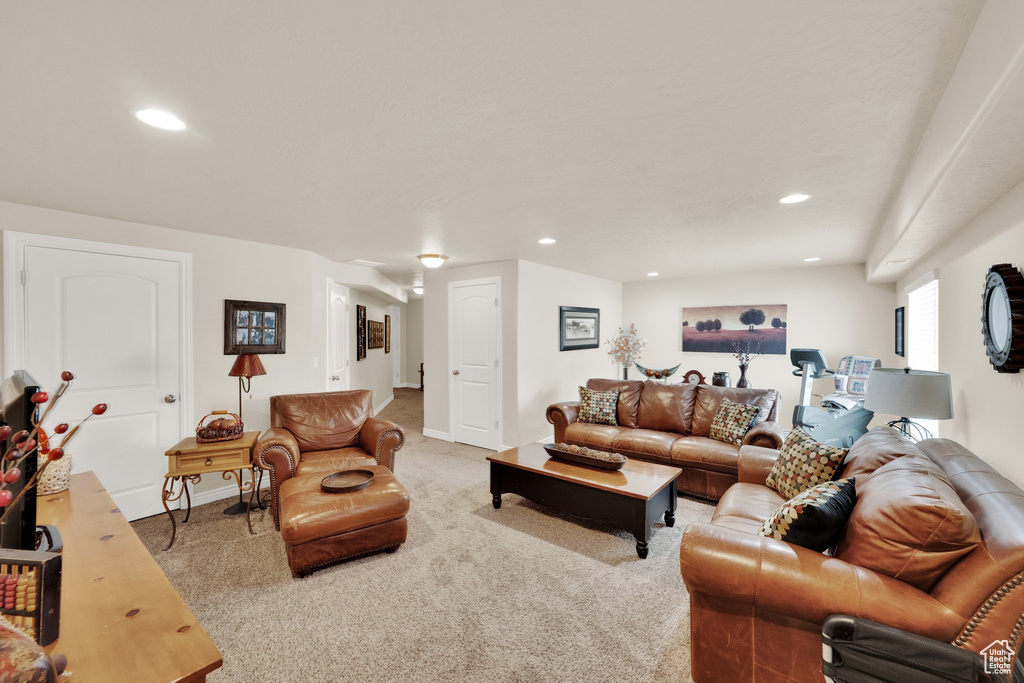 Carpeted living room featuring recessed lighting and baseboards