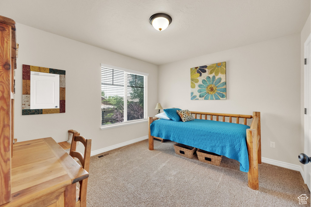 Bedroom with carpet flooring and baseboards
