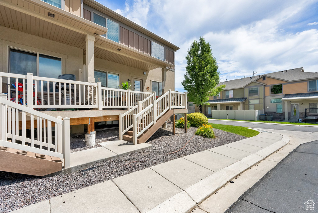 View of property with stairs and a residential view