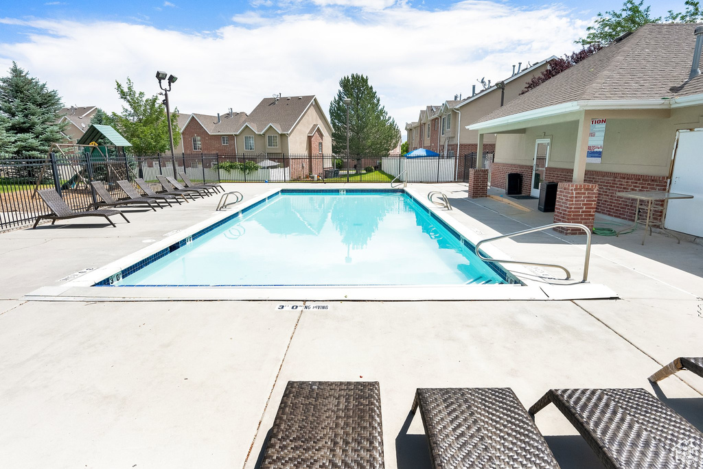 Community pool featuring a residential view and a patio