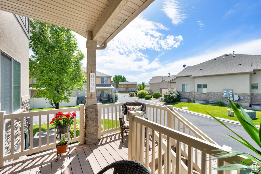 Wooden porch featuring a residential view