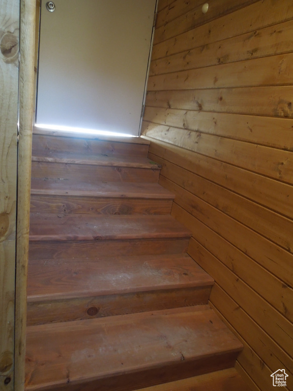 Stairs featuring wood walls