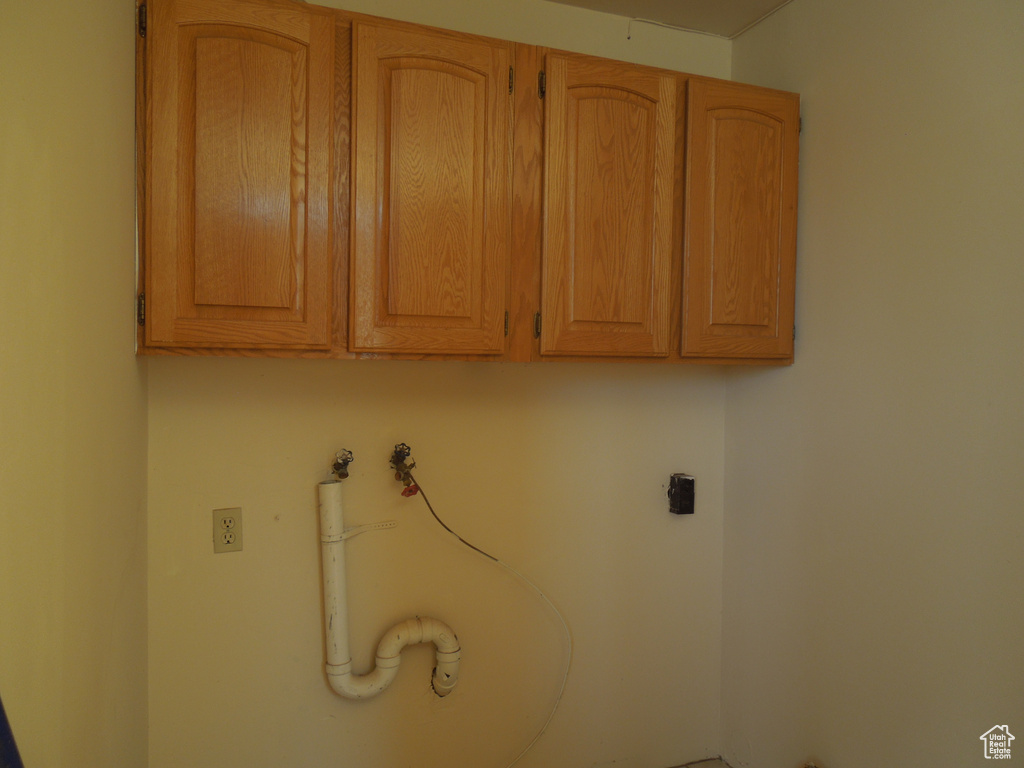 Washroom featuring cabinet space, hookup for an electric dryer, and washer hookup