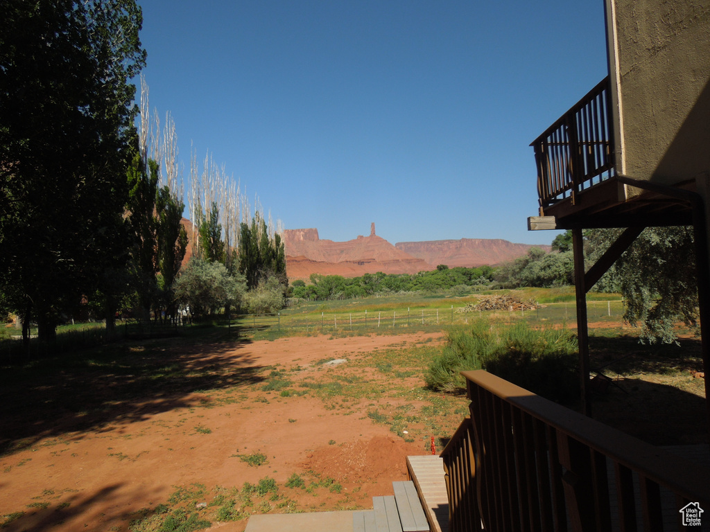 View of yard with a view of rural / pastoral area and a deck with mountain view