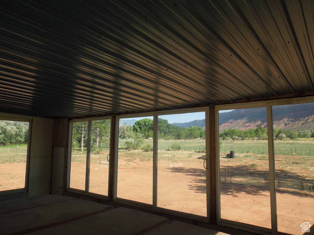 Unfurnished sunroom with a mountain view