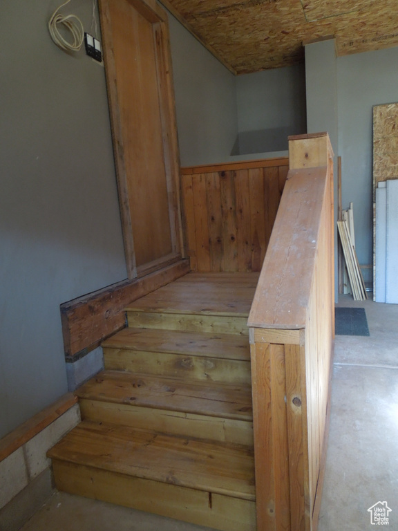 Stairway with concrete floors and wooden walls