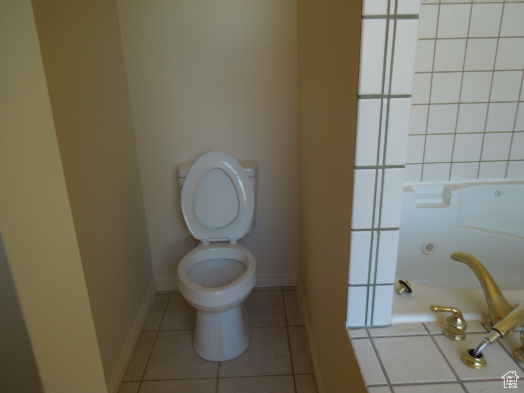 Bathroom featuring toilet and tile patterned flooring